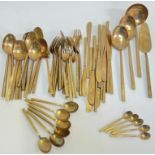 A large group of bronze cutlery comprising fifteen desert spoons (various sizes), six teaspoons (