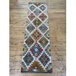 A Chobi Kilim runner rug , typically decorated. 214cm x 61cm.