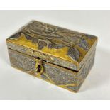 An Middle Eastern minature brass jewellery casket of domed form with white metal overlaid script and