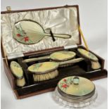 A Birmingham silver guilloche enamelled six piece brush and powder puff dressing table set including