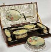 A Birmingham silver guilloche enamelled six piece brush and powder puff dressing table set including