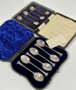 A set of London silver shell bowl tea spoons with spiral twist stems and scroll terminals in