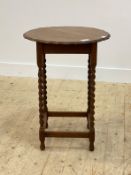 An early 20th century oak side table, with scalloped circular top raised on spiral turned supports