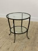 A contemporary two tier end table, with circular plate glass top raised on four splayed supports