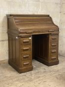 An Edwardian oak roll top desk, the serpentine tambour front with key and lock escutcheon stamped