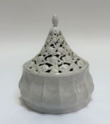 A white ceramic pagoda style serving dish with pierced cover decorated with fruit. (h- 22cm w- 15.