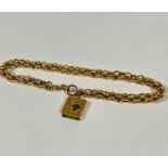 An 18ct gold triple open barrel link chain bracelet, (l 21cm) with with yellow metal Quran charm.