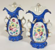 A pair of 19thc Continental porcelain flower vases in the rococo taste with scrolling tops and