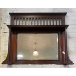 An Early 20th century mahogany over mantel mirror, with open shelf on turned pilasters enclosing a