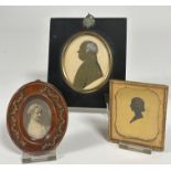 A 19thc silhouette portrait miniature of a gentleman highlighted with ink and white chalk in