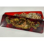 An Edwardian rectangular papier mache lacquered glove box with central panel of seated lady and