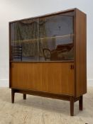 Beaver and Tapley, a mid century teak bookcase, with twin sliding glass doors enclosing an