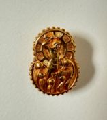An 9ct gold lapel button of gourd shape, chased with metal work figure at an anvil. (l x 2.5cm) 5.