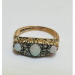 A 9ct gold three stone graduated water opal ring, the centre stone flanked by two diamond spacers,