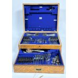 A Edwardian oak canteen containing a part suite of Old English pattern Epns flatware including