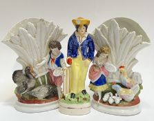 A Staffordshire pottery figure of a cricketer (h- 15cm), together with a pair of spill vases with