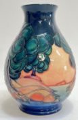 A Moorcroft pottery 'Mamoura' vase of globular form with tube lined decoration of trees and water (