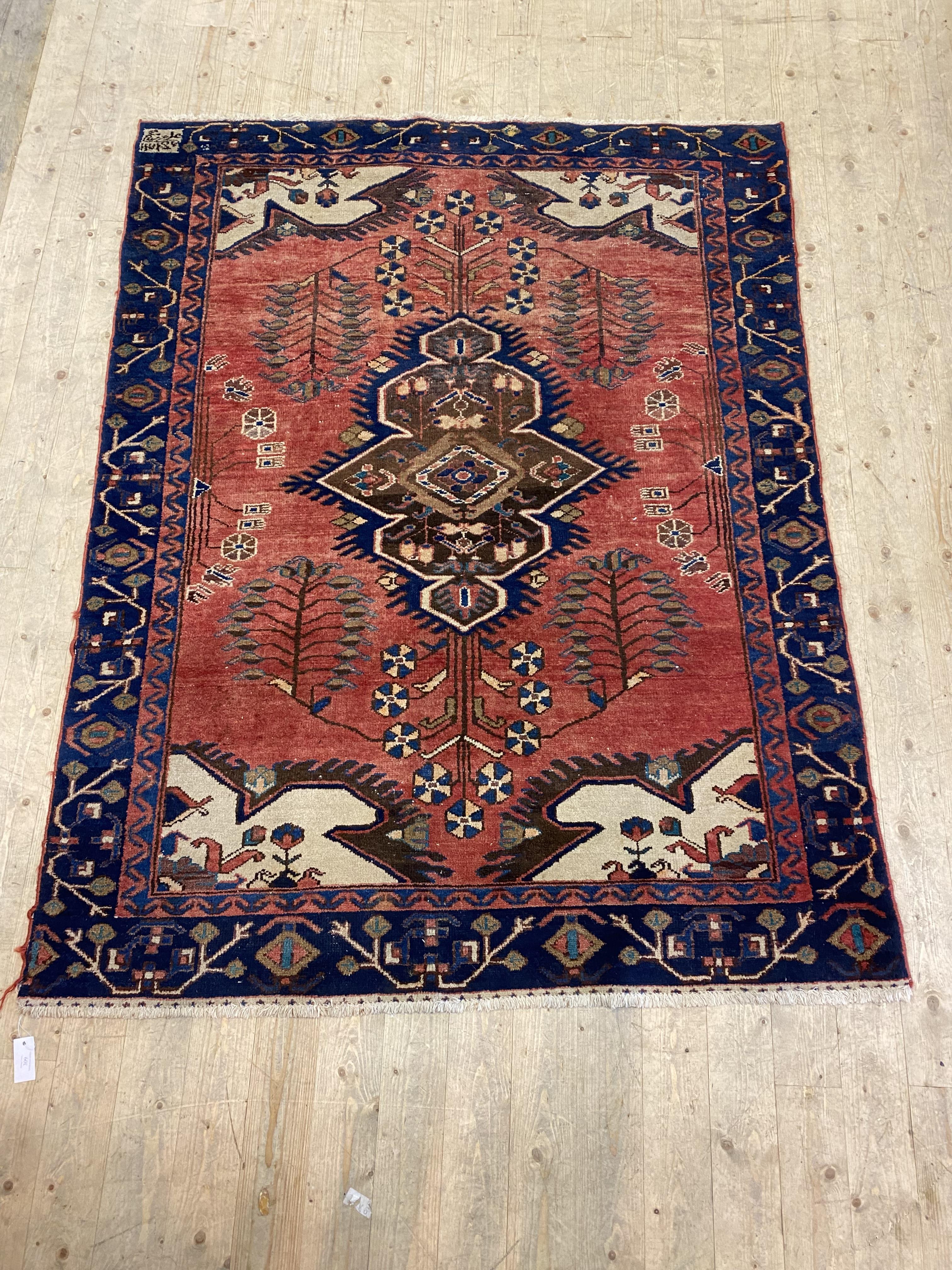 A hand knotted Persian Hamadan design rug, the red field with medallion, botehs, and ivory spandrels - Image 2 of 2
