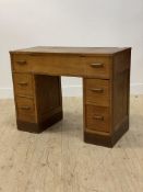 A 1940's oak dressing table, the top centre lifting to reveal a mirror and storage well, flanked