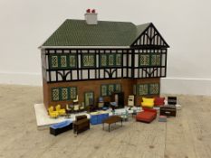 A vintage Triang dolls house, with mock Tudor facade and illuminated interior (W92cm) together