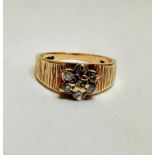 A 1970's style 9ct gold hatched seven stone diamond cluster ring, centre stone a/f, size Q, 4.83g.