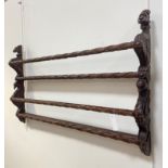 A Victorian style carved mahogany two height delft rack, the panel ends carved with lion and swan