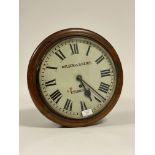 A circular mahogany cased wall clock time piece, early 20th century, the white painted dial 12" with