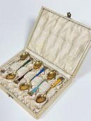 A set of six Ela Danish sterling silver gilt enamelled coffee spoons with coronet style terminals in