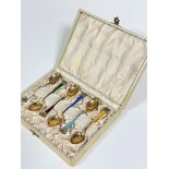 A set of six Ela Danish sterling silver gilt enamelled coffee spoons with coronet style terminals in