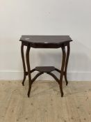 An early 20th century mahogany side table, with shaped top over tapered supports united by an