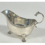 A Sheffield silver Celtic style sauce boat, with chased S scroll dragon mask handle and shield a