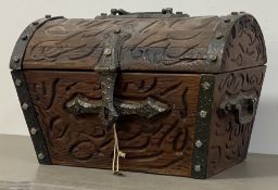 A 17th century style carved pine ships type chest with metal mounts and swing handle to each end