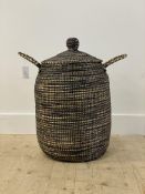 A twin handled woven laundry basket with knop to lid H66cm