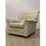 G-Plan, a mid century K'ang easy chair, upholstered in buttoned ivory damask, moving on castors,