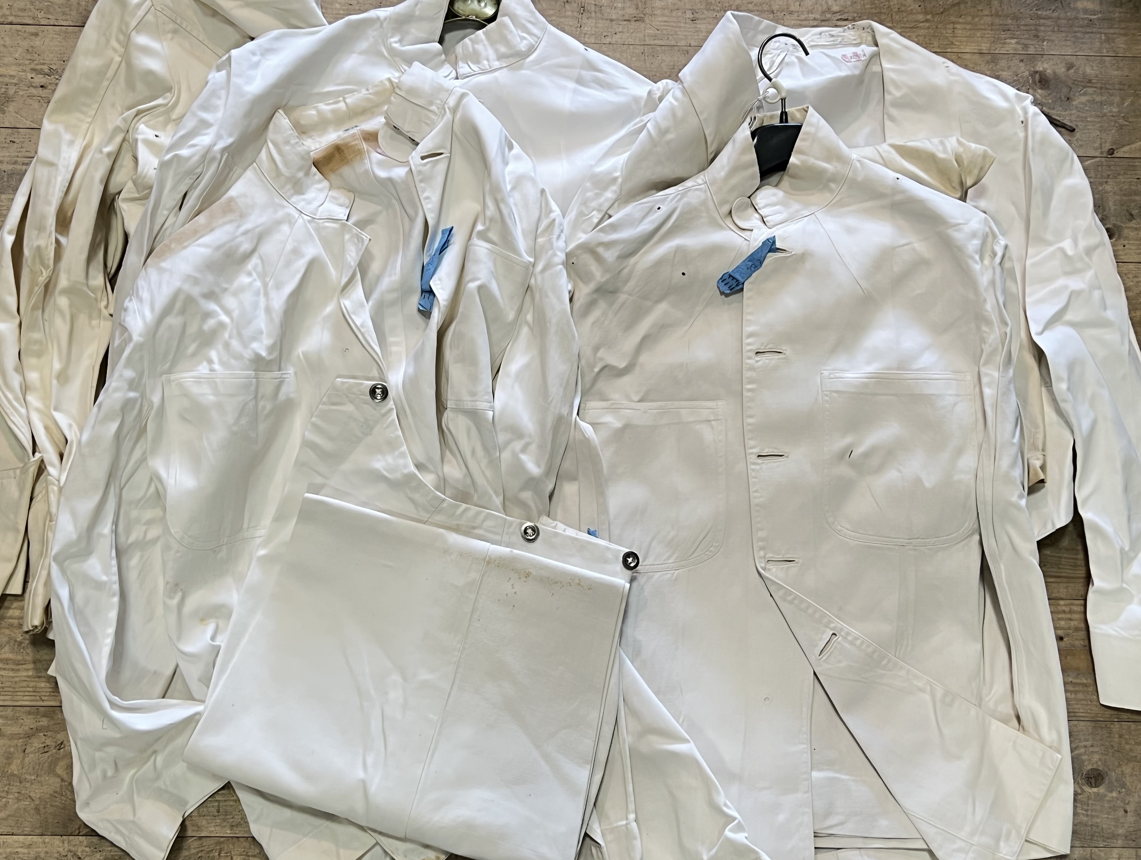A mixed lot of Naval Officer's tropical white uniforms and mess kit