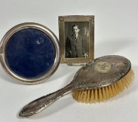 A modern circular silver photograph frame with plush back and easil stand (D x 10.5cm) a modern