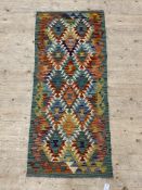 A Chobi kilim runner rug, of geometric design 146cm x 63cm