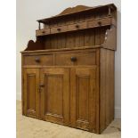 A Victorian pine dresser, the open shelf over four spice drawers, above two drawers and three