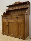 A Victorian pine dresser, the open shelf over four spice drawers, above two drawers and three