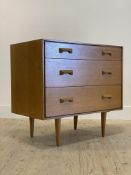 Stag, a mid century light oak veneered chest fitted with three drawers, raised on turned supports