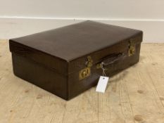 A 1930's snakeskin suitcase, with brass lock plates and swing handle, the lid opening to a silk