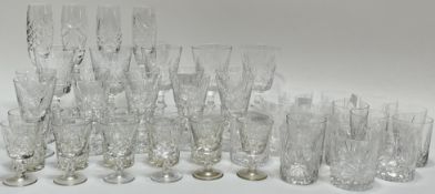 A large group of cut crystal drinking glasses comprising four champagne flutes (h- 23.5cm), five