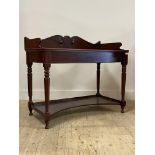 A mid 19th century mahogany wash stand, the scroll carved raised back over rectangular top with