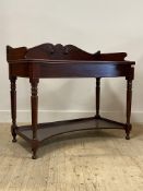 A mid 19th century mahogany wash stand, the scroll carved raised back over rectangular top with