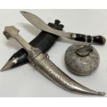 A mixed group of tourist wares comprising a kukri dagger set and leather scabbard (also including