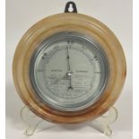 A Art Deco Onyx circular stepped wall mounted Aneroid Barometer with silvered dial and chrome mount,