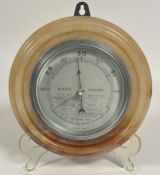 A Art Deco Onyx circular stepped wall mounted Aneroid Barometer with silvered dial and chrome mount,