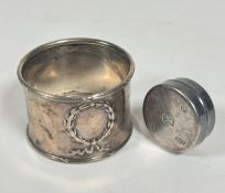 A modern silver circular pill box, (D x 3cm) and a Birmingham silver napkin ring, marks rubbed, (