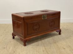 A Chinese hardwood blanket box, the lid and panelled front carved with Shou symbol motif, opening to