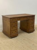 A Victorian oak twin pedestal desk, the top lacking inset writing surface, above one long and